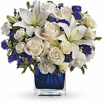 <div class="m-pdp-tabs-description">
<div id="mark-1" class="m-pdp-tabs-marketing-description">Send someone a bit of heaven with this beautiful bouquet. Luxurious crème roses and pure white lilies paint a peaceful picture inside a blue cube.</div>
</div>
<p id="arrngDescp">Crème roses, white asiatic lilies and white miniature carnations are mixed with bursts of purple statice and green pitta negra. Delivered in a glass cube.</p>