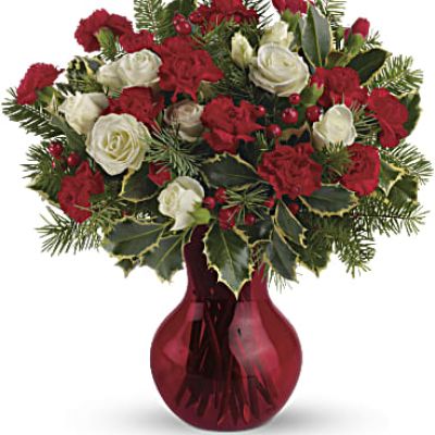 Fill your winter with joy. This sweet arrangement features white spray roses and red miniature carnations presented in our sweet red Serendipity vase.
White spray roses and red miniature carnations are accented with tips of douglas fir, holly and red berry spray.