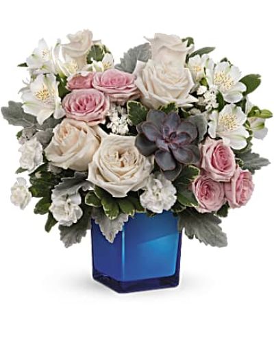 <div id="mark-3" class="m-pdp-tabs-marketing-description">Soft as a whisper, this enchanting bouquet of cream and pink roses looks oh-so-lovely in a glass cube that later becomes a comely candleholder.</div>
&nbsp;
<div id="desc-3">Crème roses, pink spray roses, white alstroemeria and miniature white carnations are arranged with variegated pittosporum, dusy miller, white sinuata statice and a large, potted green echeveria succulent.</div>