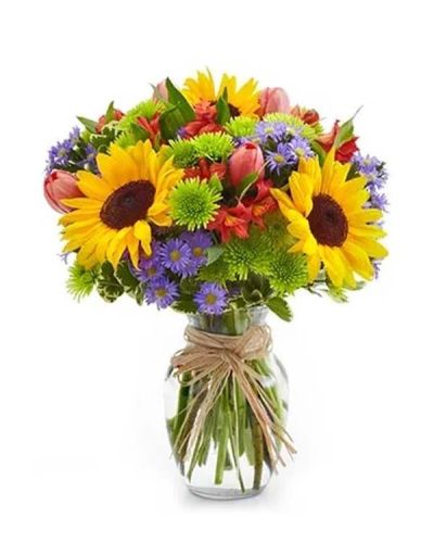 The essence of a Europe garden comes to life in all its grandeur with this bright assortment of alstroemeria, button poms, Monte casino, sunflowers and tulips arranged in an elegant clear glass vase.