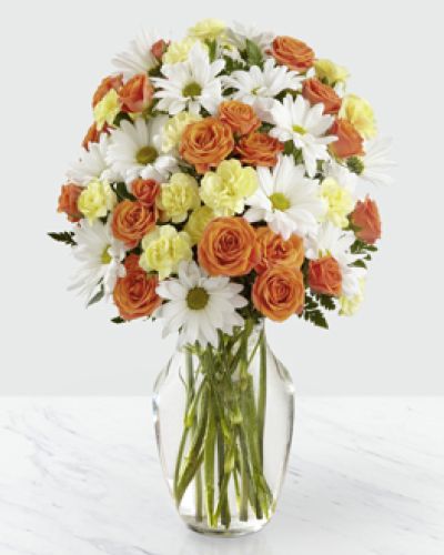 The Sweet Splendor Bouquet has a citrus sweet vibe that is set to help you celebrate your special recipient! White traditional daisies provide a perfectly beautiful background for the bold colors of the orange spray roses and yellow mini carnations to pop, making this an unforgettable fresh flower arrangement.
