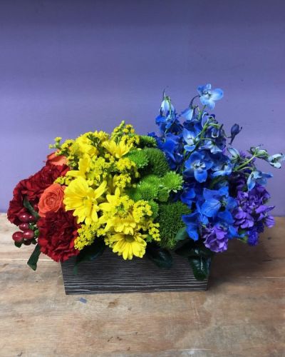 This bouquet is all about capturing the color of your unique love. With a rainbow color pallete, this arrangement has everything from bold reds to vibrant violets, and the all gorgeous hues in between! Our Color of Love Bouquet is made up of a wide array of blooming beauties like carnations, roses, button pompons and more.
