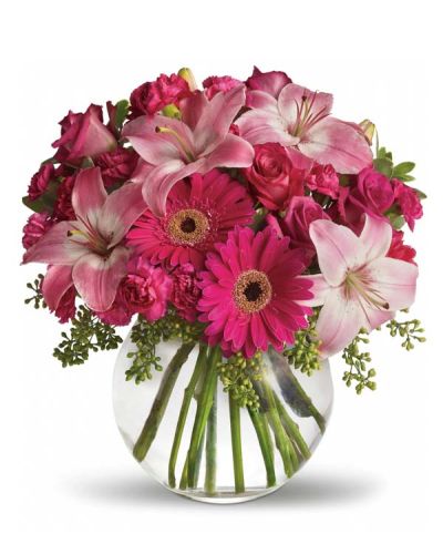 Youthful. Graceful. Beautiful ... she'll be Tickled Pink by this gorgeous bouquet of flowers. Lovely pink roses and Asiatic lilies are joined by hot pink gerberas and miniature carnations, pink full-sized carnations and more in a clear glass ball. Whether you want this arrangement to say "Happy Anniversary" or "Happy Any Day," you can be sure the day it arrives will be brighter for anyone lucky enough to receive it.