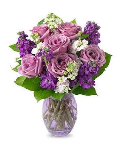 Lovely lavender roses, lavender stock, and pink stock are accented with a variety of lush greens in this amazing floral arrangement. Presented in a glass vase, the bouquet is a wonderful gift to help celebrate an anniversary, a birthday, or just because.